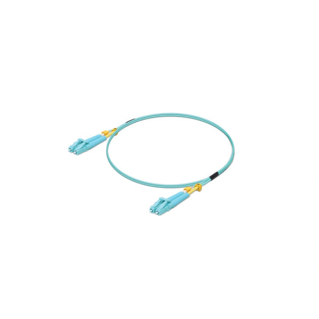 Vista cenital de cable duplex OM3 azul con dos conectores LC, clips amarillos y botas negras de protección