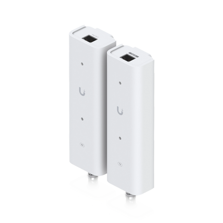 Dos adaptadores blancos Ubiquiti con puertos Ethernet y conectores coaxiales, logotipo U gris y etiquetas RX TX visibles.