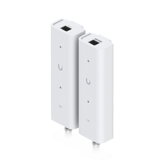 Dos adaptadores blancos Ubiquiti con puertos Ethernet y conectores coaxiales, logotipo U gris y etiquetas RX TX visibles.