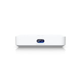 Vista frontal del gateway UniFi blanco con pantalla LCD a color mostrando estadísticas de red y clientes